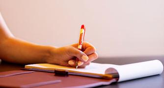 Image of a pen writing on paper.